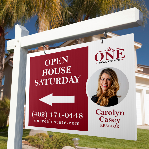 Real estate sign for an open house with a Realtor's name and contact information.