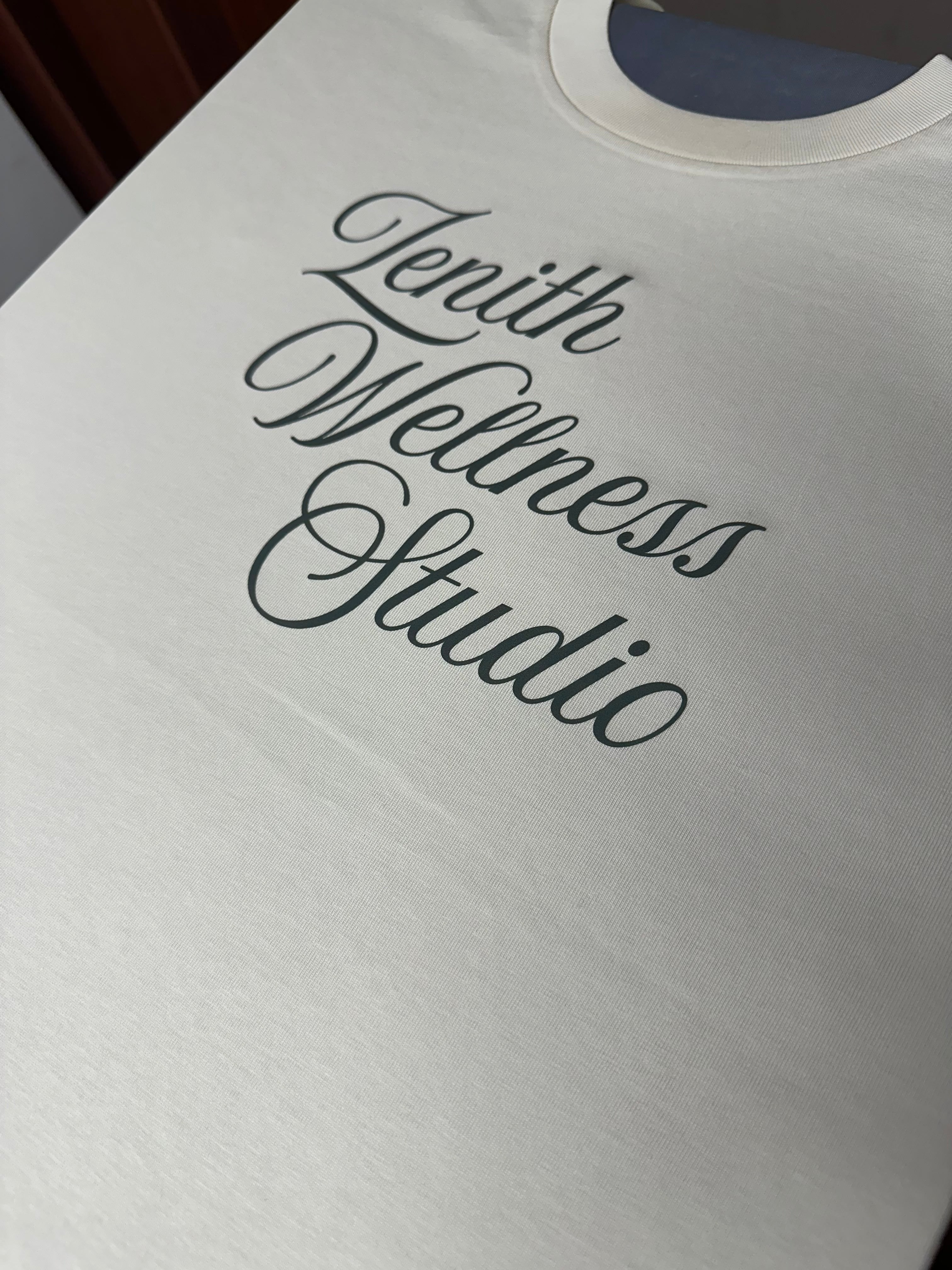 White garment with 'Zenith Wellness Studio' text on a plain background