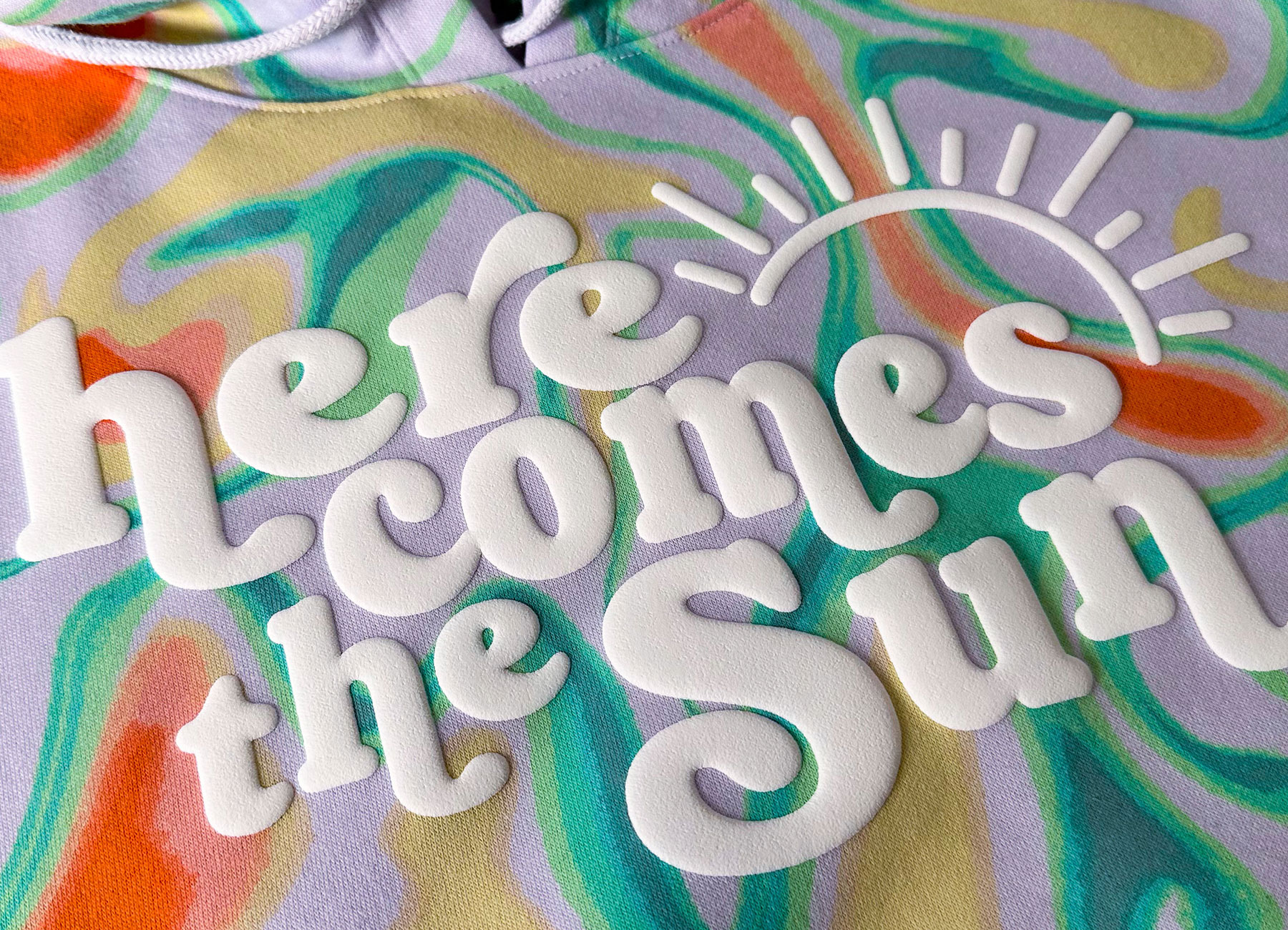 Hoodie laid flat with bold puff print logo across the front.
