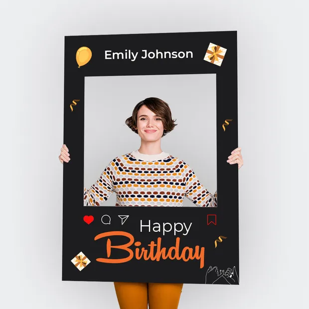 Person holding a birthday-themed photo frame with 'Emily Johnson' and 'Happy Birthday' text.