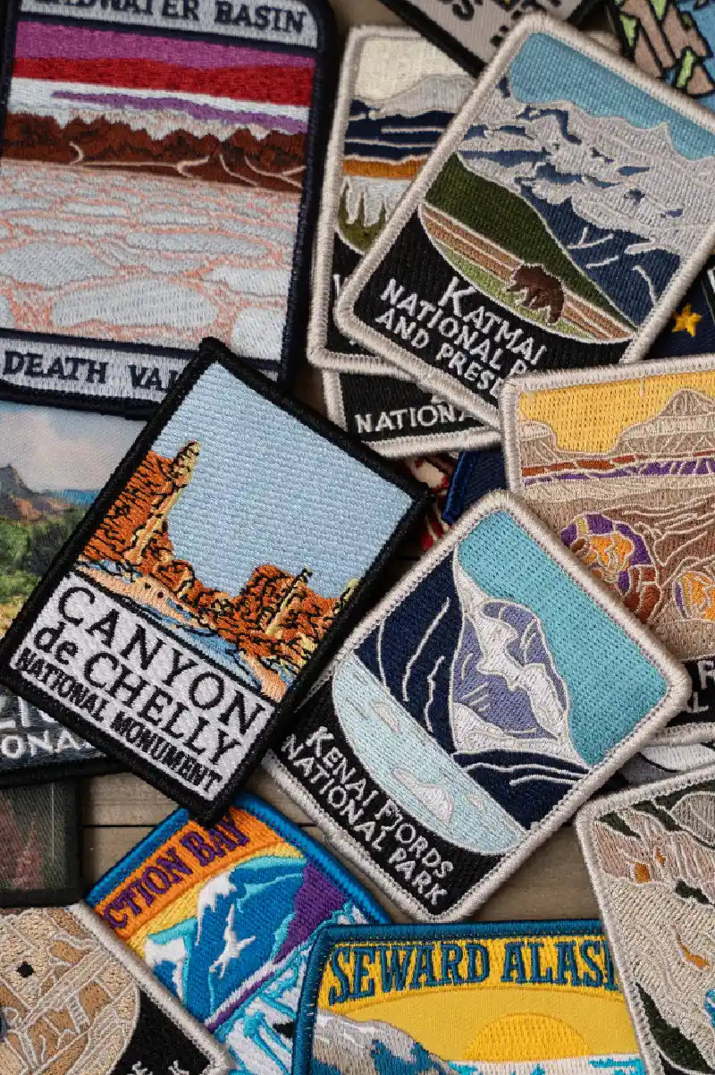 Collection of embroidered patches with national park designs.