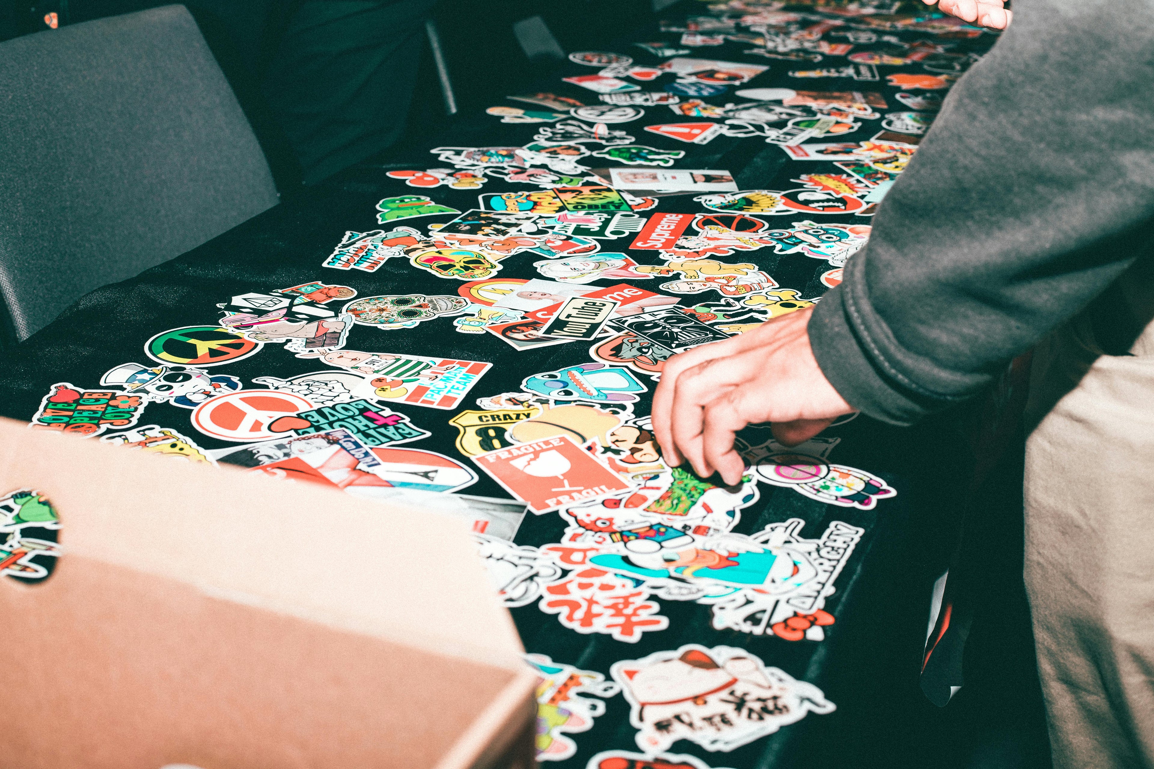 Custom logo stickers displayed on a table for promotional use.