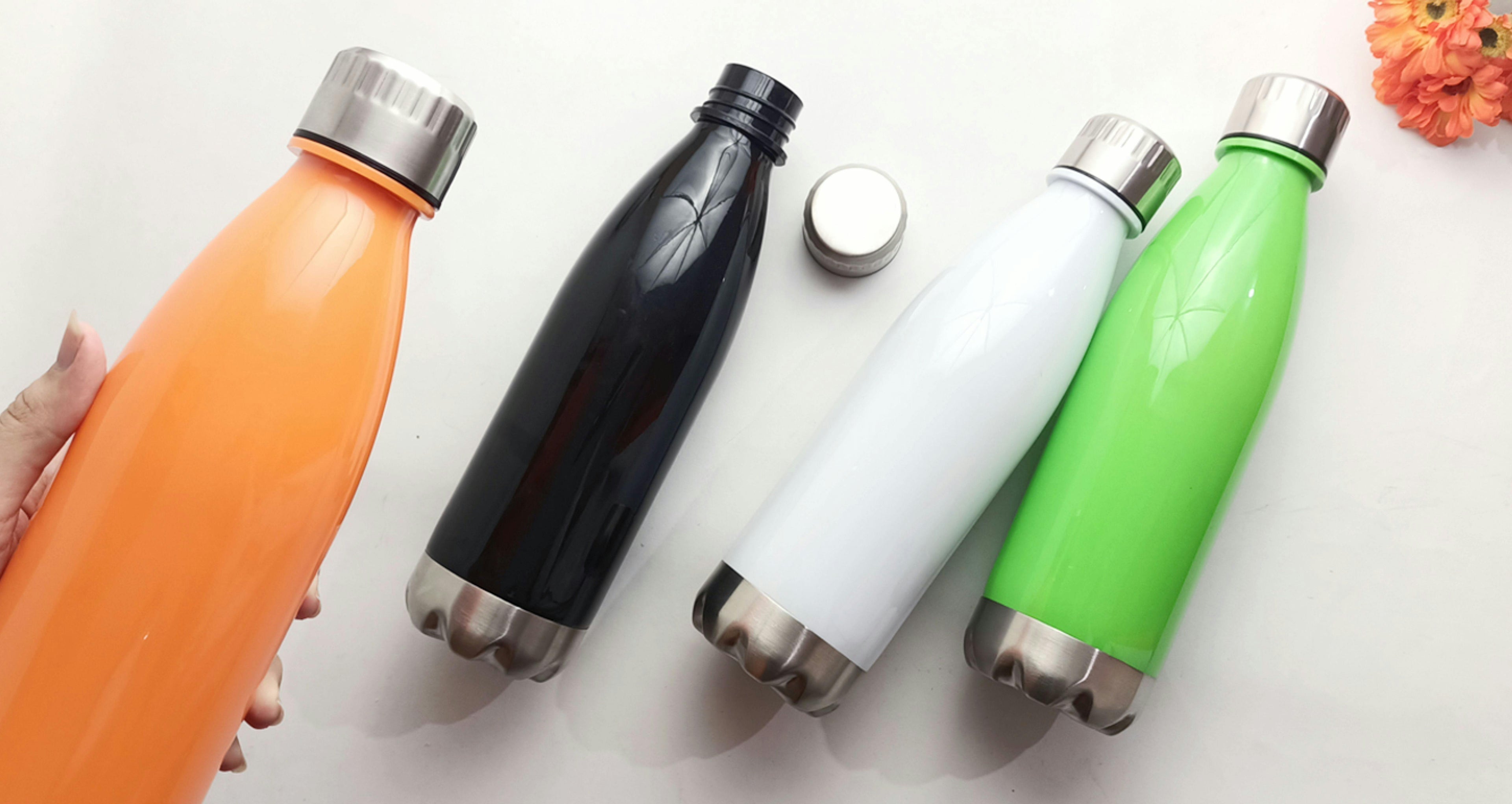 Assorted water bottles lined up on a table, no branding.